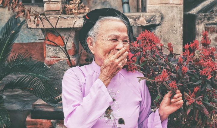 ageing / aging esl conversation worksheets. old lady wearing a pink cardigan, laughing in the garden