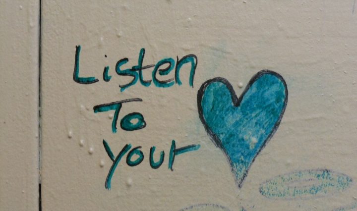 graffiti on the wall, written "listen to your heart", giving advice to strangers